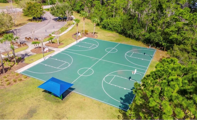 view of sport court with a yard