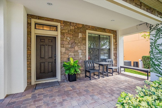 property entrance with cooling unit and covered porch