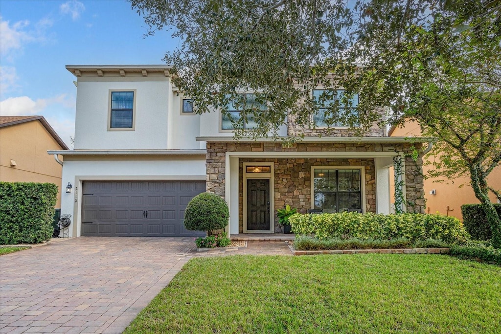 view of front of house with a front yard and a garage