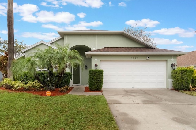 view of front of property featuring a garage and a front lawn