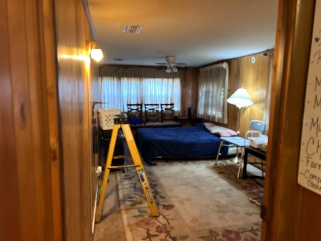 bedroom featuring wooden walls