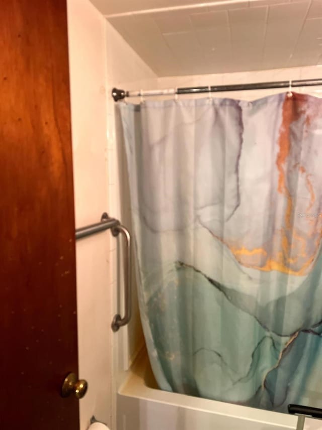 bathroom with shower / bath combination with curtain