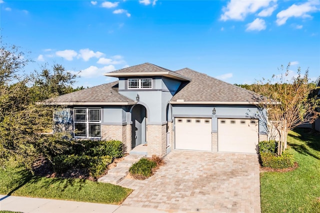 view of front of property featuring a front yard and a garage