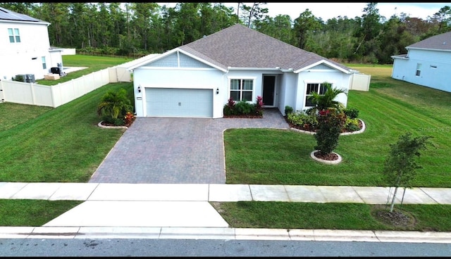 view of front of home featuring a garage and a front lawn