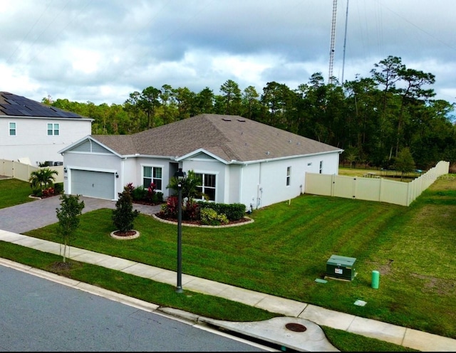 view of front of house with a garage and a front lawn