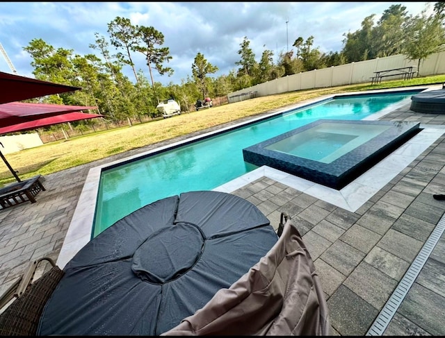 view of swimming pool featuring a patio area, an in ground hot tub, and a yard