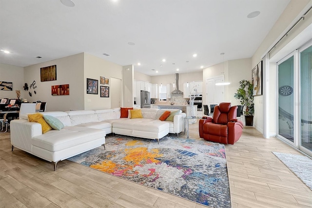 living room with visible vents, recessed lighting, and wood tiled floor