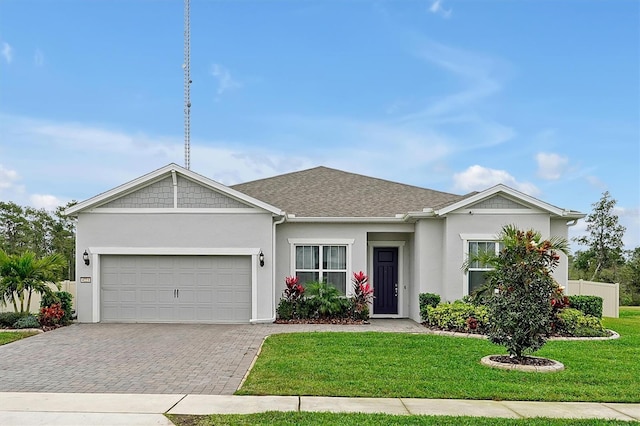 single story home featuring stucco siding, decorative driveway, a front yard, a shingled roof, and a garage