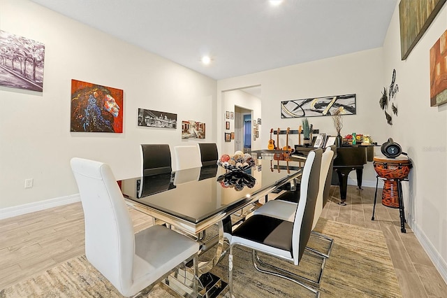 dining room with recessed lighting, baseboards, and light wood-style floors