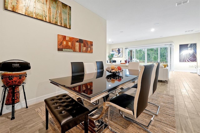 dining area featuring visible vents, recessed lighting, baseboards, and wood tiled floor