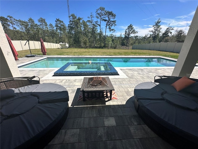 view of swimming pool featuring a patio, a fire pit, a lawn, and a fenced backyard