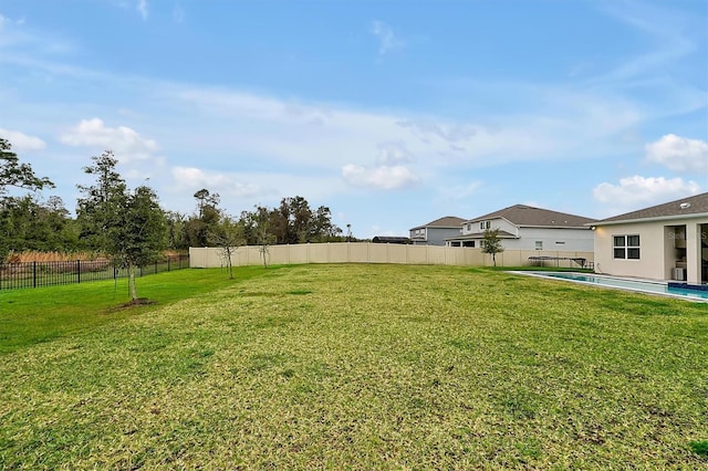 view of yard featuring fence and a fenced in pool