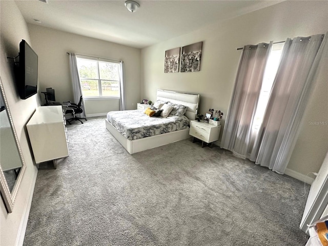 bedroom with baseboards and light carpet