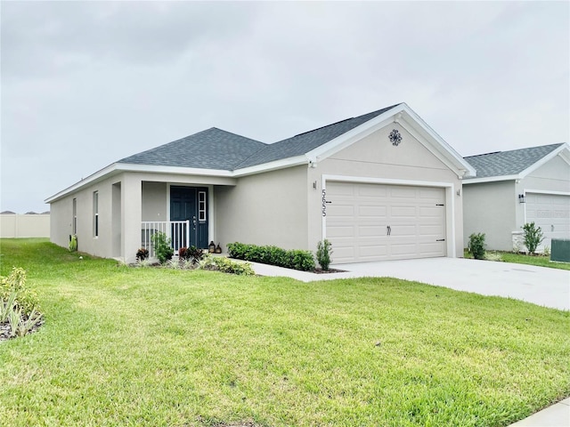 single story home with a porch, a front yard, and a garage