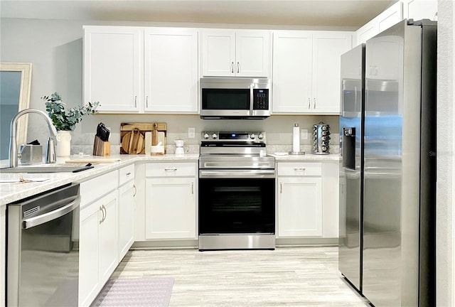 kitchen featuring sink, white cabinetry, and stainless steel appliances