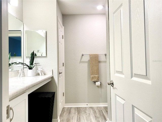 bathroom featuring vanity and wood-type flooring