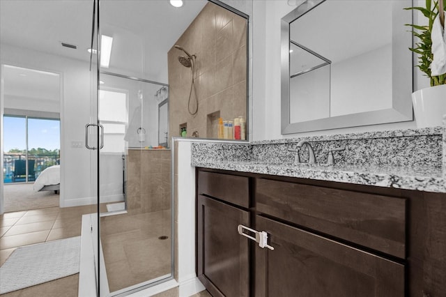 bathroom featuring tile patterned floors, vanity, and an enclosed shower