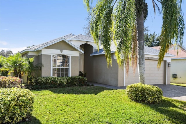 view of front facade featuring a garage and a front lawn