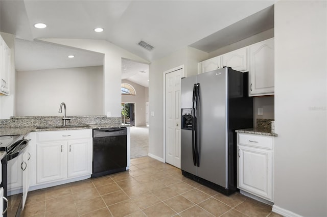 kitchen with sink, black appliances, white cabinets, stone countertops, and vaulted ceiling