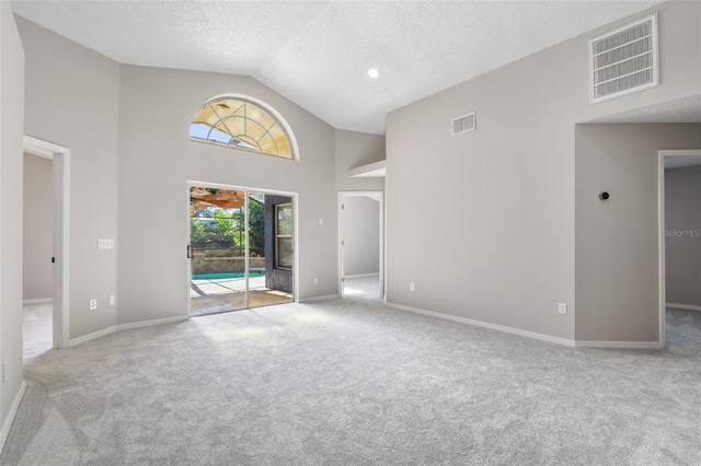 unfurnished living room featuring high vaulted ceiling, light carpet, and a textured ceiling