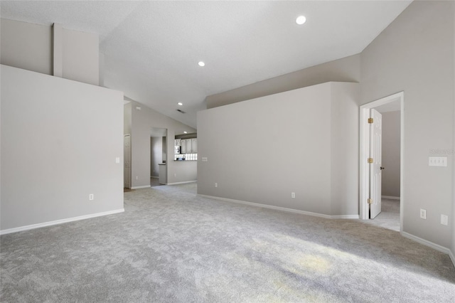 unfurnished living room featuring light colored carpet and lofted ceiling