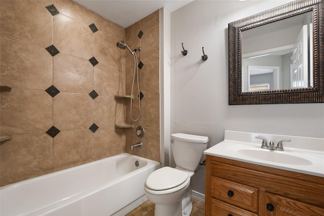 full bathroom featuring vanity, tiled shower / bath, and toilet