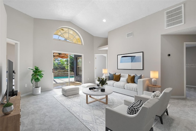 carpeted living room featuring high vaulted ceiling and a textured ceiling