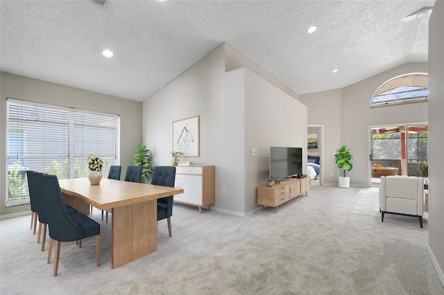 carpeted dining space featuring a healthy amount of sunlight, lofted ceiling, and a textured ceiling