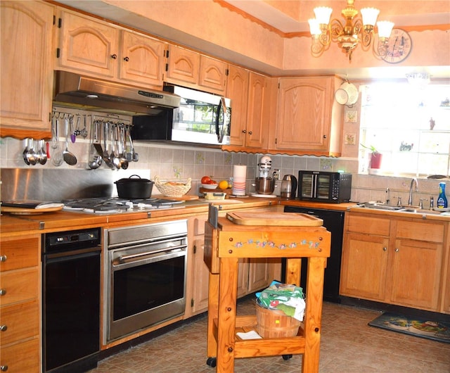 kitchen with sink, a chandelier, extractor fan, decorative backsplash, and black appliances