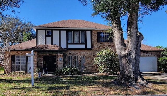 view of front of property with a garage and a front yard