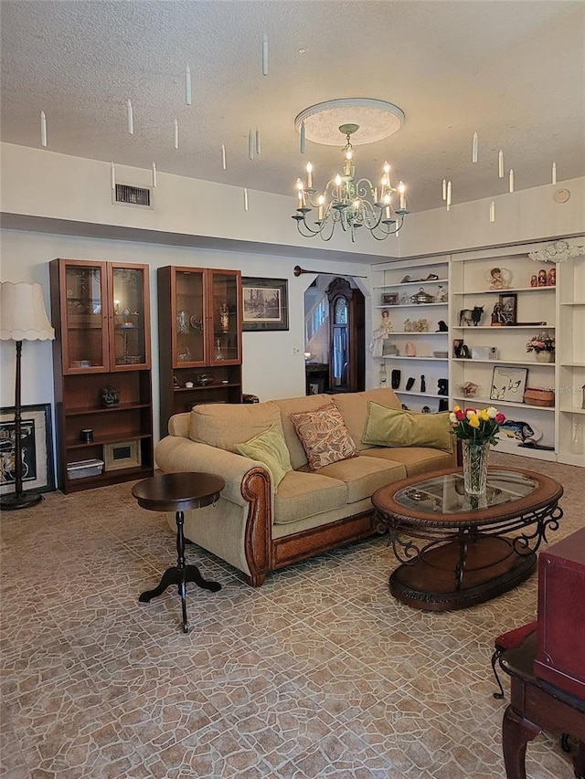 living room with a textured ceiling and a chandelier