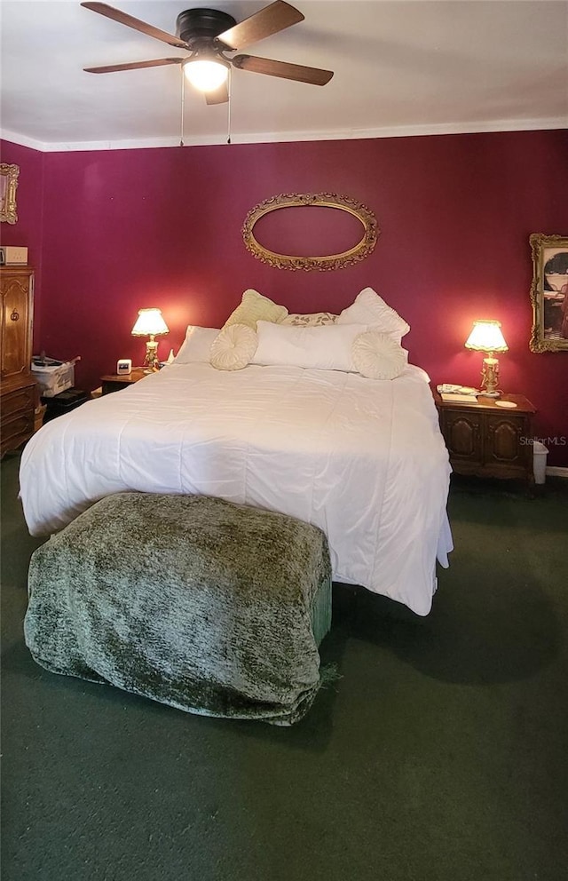 carpeted bedroom featuring crown molding and ceiling fan