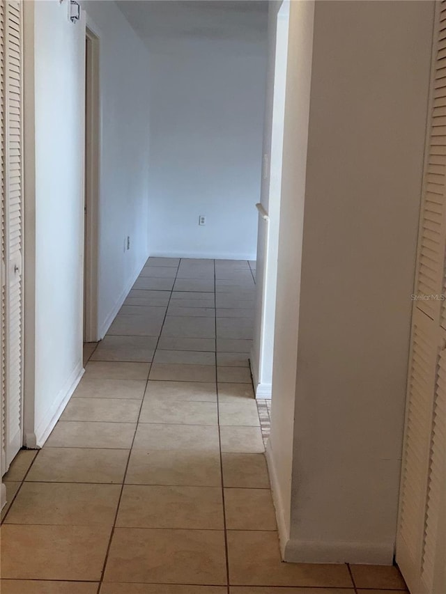 corridor with light tile patterned floors