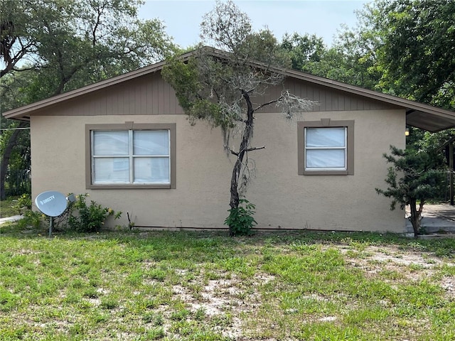 view of property exterior with a yard