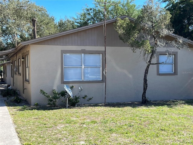 view of side of property with a yard