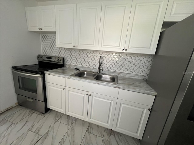 kitchen featuring decorative backsplash, stainless steel appliances, white cabinetry, and sink