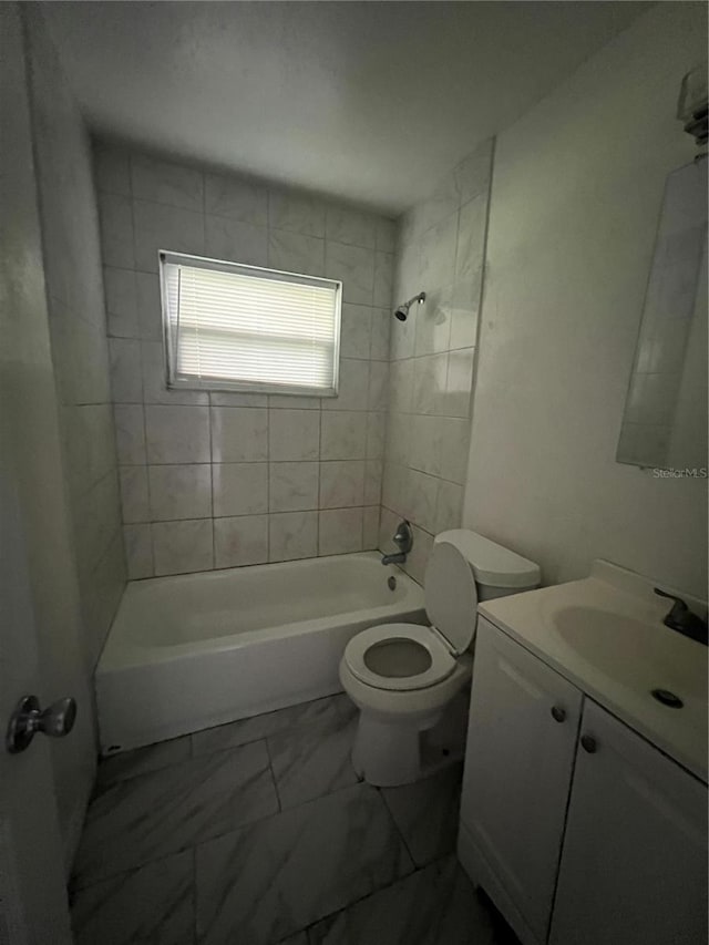 full bathroom featuring toilet, vanity, and tiled shower / bath