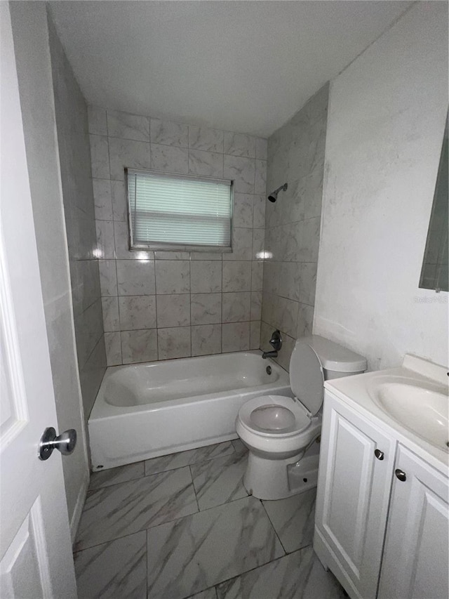 full bathroom with vanity, toilet, and tiled shower / bath