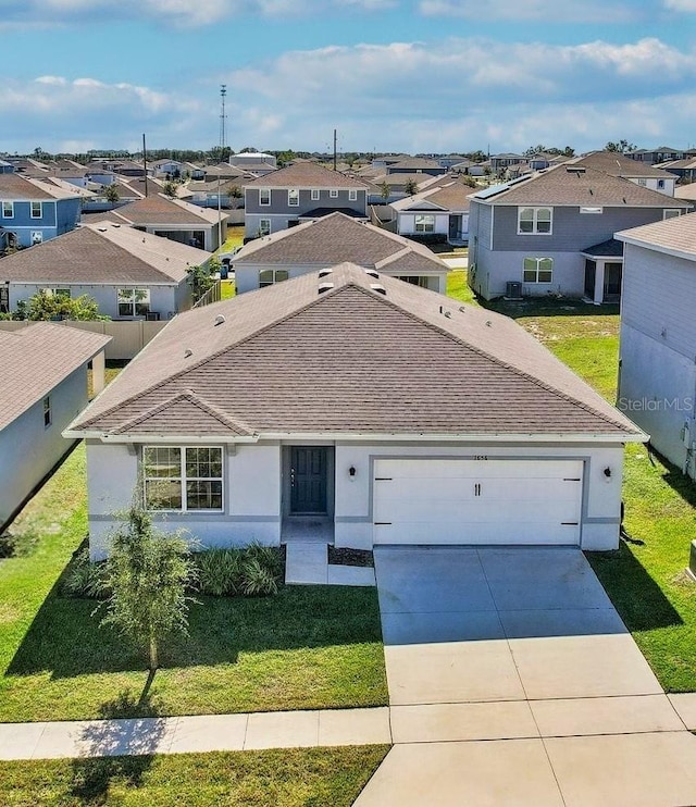 view of front of home featuring a garage and a front yard