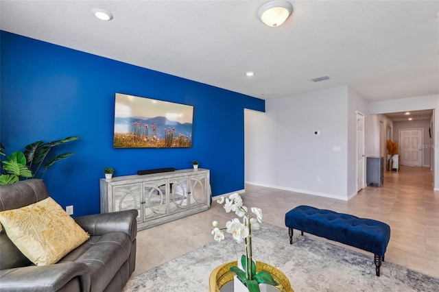 tiled living area with baseboards, visible vents, and recessed lighting