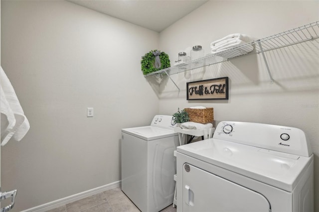 laundry room featuring washer and dryer, laundry area, baseboards, and light tile patterned floors