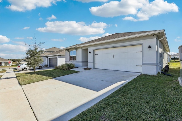 single story home featuring a garage, a front lawn, concrete driveway, and stucco siding