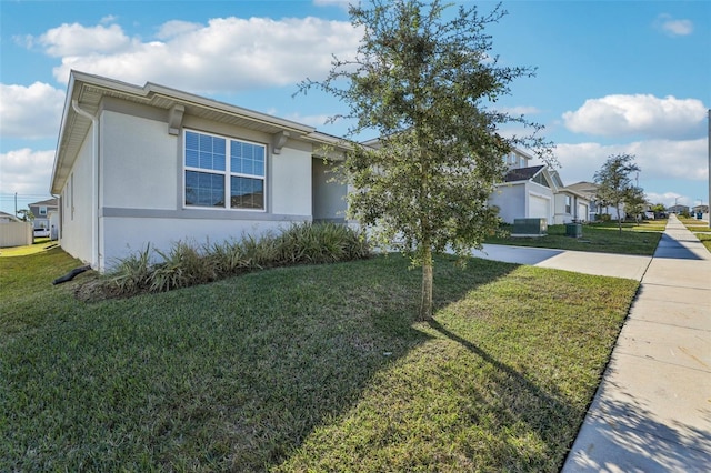 view of front facade featuring a front yard, driveway, an attached garage, and stucco siding