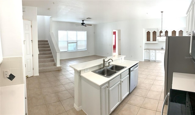 kitchen with white cabinets, sink, hanging light fixtures, a kitchen island with sink, and stainless steel dishwasher