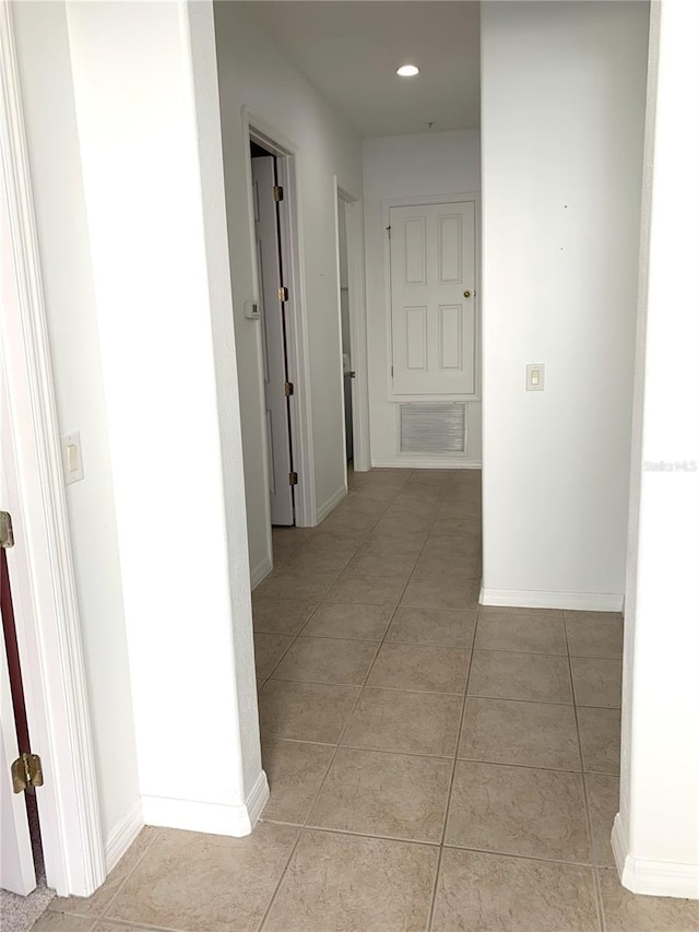 hallway featuring light tile patterned flooring