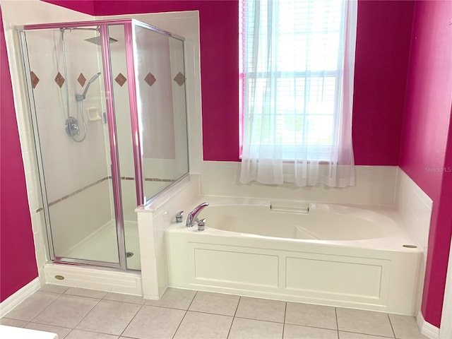 bathroom featuring shower with separate bathtub and tile patterned flooring