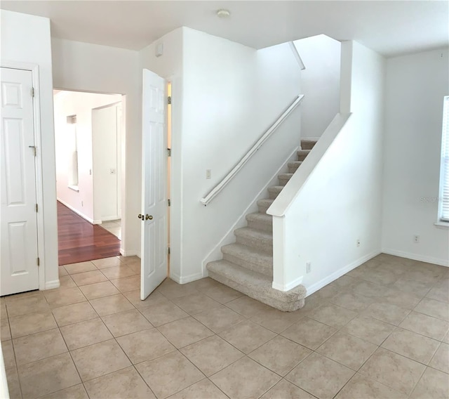 stairs featuring tile patterned flooring