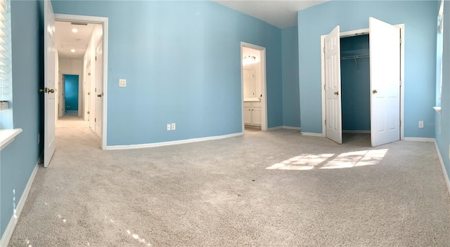 unfurnished bedroom featuring a closet and connected bathroom