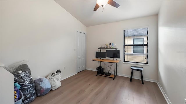 interior space with lofted ceiling, a ceiling fan, baseboards, and wood finished floors