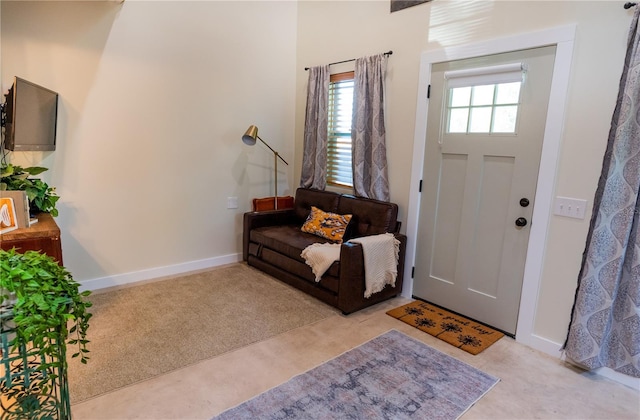 foyer entrance featuring light carpet